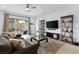 Bright living room with access to the backyard and modern entertainment center at 9993 Skye Gazer Ave, Las Vegas, NV 89166