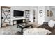 A well-lit living room featuring modern furniture, tile flooring, and stylish decor at 9993 Skye Gazer Ave, Las Vegas, NV 89166