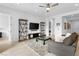 Open concept living room with modern furnishings, tile floors, and neutral decor at 9993 Skye Gazer Ave, Las Vegas, NV 89166