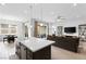 Open-concept living area with a kitchen island and comfortable living room setup at 9993 Skye Gazer Ave, Las Vegas, NV 89166
