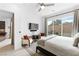 Bright bedroom with backyard access, plush bedding, stylish rug, and comfortable accent chairs at 9993 Skye Gazer Ave, Las Vegas, NV 89166
