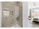 Glass enclosed shower with tile surround, and backyard view from bedroom at 9993 Skye Gazer Ave, Las Vegas, NV 89166