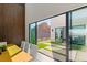 Modern dining room featuring wood wall and glass doors leading to outdoor living area at 10 Sand Star Ln, Henderson, NV 89011