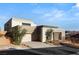 Modern home with a desert landscape, a multi-car garage, and an inviting entrance enhanced by mature trees at 10 Sand Star Ln, Henderson, NV 89011