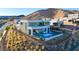 Stunning modern home with a sleek pool, outdoor seating area, and mountain views at 10 Sand Star Ln, Henderson, NV 89011