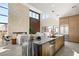 Modern kitchen with island, luxury countertops, and view to the living room at 10 Sand Star Ln, Henderson, NV 89011