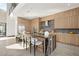 Gourmet kitchen with custom wood cabinetry, a waterfall-edge island, and stainless steel appliances, perfect for entertaining at 10 Sand Star Ln, Henderson, NV 89011