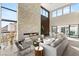 Spacious living room boasts high ceilings, a stone fireplace, and large windows offering panoramic mountain views at 10 Sand Star Ln, Henderson, NV 89011