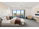 Bright main bedroom featuring a king bed, sitting area, and a beautiful view of the backyard pool at 10 Sand Star Ln, Henderson, NV 89011