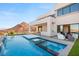 Stunning backyard pool and spa with mountain views, plus an outdoor seating area and built-in grill for entertaining at 10 Sand Star Ln, Henderson, NV 89011