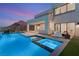 Backyard oasis featuring a sparkling pool, integrated spa, and mountain views at 10 Sand Star Ln, Henderson, NV 89011