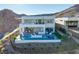 Luxury home with a modern pool, outdoor seating, and scenic mountain views at 10 Sand Star Ln, Henderson, NV 89011