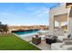 Beautiful backyard features a luxurious pool, outdoor kitchen, and serene desert views at 10 Sand Star Ln, Henderson, NV 89011