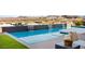 Inviting pool showcasing pristine water, lush greenery, and panoramic mountain views for ultimate relaxation at 10 Sand Star Ln, Henderson, NV 89011