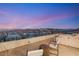 Enjoy amazing views from this home's rooftop deck featuring lounge seating and iron railing at 10 Sand Star Ln, Henderson, NV 89011