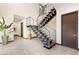 Modern staircase features sleek metal railings and stone wall accents, adding architectural interest to the home's entry at 10 Sand Star Ln, Henderson, NV 89011
