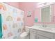 Charming bathroom with rainbow shower curtain, white vanity, and pink walls at 10412 Mansion Hills Ave, Las Vegas, NV 89144