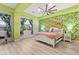 Spacious bedroom with tropical wallpaper, modern ceiling fan and bright green trim at 10412 Mansion Hills Ave, Las Vegas, NV 89144