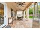 Inviting covered patio with ceiling fans, a dining table, and patio heater at 10412 Mansion Hills Ave, Las Vegas, NV 89144