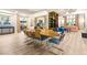 Open dining area with modern chandelier and view into living room at 10412 Mansion Hills Ave, Las Vegas, NV 89144
