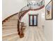 Grand foyer with hardwood floors, staircase, and elegant lighting at 10412 Mansion Hills Ave, Las Vegas, NV 89144