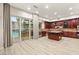 Open kitchen with granite countertops, an island, stainless steel appliances, and patio access at 10412 Mansion Hills Ave, Las Vegas, NV 89144
