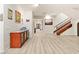 Open floor plan living room with light hard wood flooring and staircase to upper level at 10412 Mansion Hills Ave, Las Vegas, NV 89144