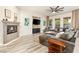 Living room boasts a fireplace, media center, and backyard views at 10412 Mansion Hills Ave, Las Vegas, NV 89144