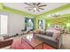 Sitting room with tropical wallpaper accent wall, couch and work out space at 10412 Mansion Hills Ave, Las Vegas, NV 89144