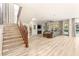 Spacious living room with wood staircase, fireplace, and access to backyard pool at 10412 Mansion Hills Ave, Las Vegas, NV 89144