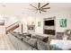 Comfortable living area with fireplace, tv, and cozy gray sectional sofa at 10412 Mansion Hills Ave, Las Vegas, NV 89144