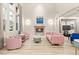Bright living room with fireplace, large windows and stylish pink furniture at 10412 Mansion Hills Ave, Las Vegas, NV 89144