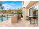 Spacious outdoor kitchen and patio area with a pool view perfect for entertaining guests at 10412 Mansion Hills Ave, Las Vegas, NV 89144