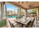 Lovely covered patio featuring a dining area and an outdoor kitchen overlooking the pool at 10412 Mansion Hills Ave, Las Vegas, NV 89144