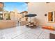 Relaxing patio area featuring a dining set with umbrella and stamped concrete flooring at 10412 Mansion Hills Ave, Las Vegas, NV 89144