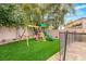 Charming backyard featuring a wooden playground and artificial grass at 10412 Mansion Hills Ave, Las Vegas, NV 89144