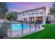 Backyard pool area with a safety fence and mature landscaping at 10412 Mansion Hills Ave, Las Vegas, NV 89144