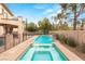 Inviting pool and spa with beautiful landscaping, outdoor kitchen, and play area at 10412 Mansion Hills Ave, Las Vegas, NV 89144
