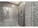 Modern gray tile shower with chrome hardware and accent lighting at 10412 Mansion Hills Ave, Las Vegas, NV 89144
