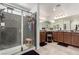 Beautiful bathroom features a large granite vanity, shower, and a stool at 10604 Sariah Skye Ave, Las Vegas, NV 89166