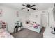 Bright bedroom features two twin beds, toys, and a large window at 10604 Sariah Skye Ave, Las Vegas, NV 89166