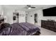 Bright primary bedroom with a ceiling fan, carpet, and a walk-in closet at 10604 Sariah Skye Ave, Las Vegas, NV 89166