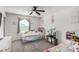 Bright bedroom features two twin beds, toys, and a large window at 10604 Sariah Skye Ave, Las Vegas, NV 89166