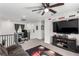 Spacious bonus room features a large TV, a ceiling fan, and comfortable seating for watching movies and television at 10604 Sariah Skye Ave, Las Vegas, NV 89166