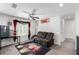 Relaxing upstairs bonus room with a ceiling fan, a mini-refrigerator, comfortable seating, and movie-themed decorations at 10604 Sariah Skye Ave, Las Vegas, NV 89166
