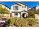Charming two-story home featuring neutral stucco, arched entry, shutters, and a well-maintained front yard at 10604 Sariah Skye Ave, Las Vegas, NV 89166