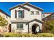 Charming two-story home featuring neutral stucco, arched entry, shutters, and a well-maintained front yard at 10604 Sariah Skye Ave, Las Vegas, NV 89166