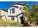 Charming two-story home featuring neutral stucco, arched entry, shutters, and a well-maintained front yard at 10604 Sariah Skye Ave, Las Vegas, NV 89166