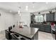 Well-designed kitchen with grey cabinets, granite counters, a tile backsplash, a center island, and modern fixtures at 10604 Sariah Skye Ave, Las Vegas, NV 89166