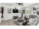 Modern living room featuring a comfortable gray sectional sofa, mounted TV, and stylish decor at 10604 Sariah Skye Ave, Las Vegas, NV 89166